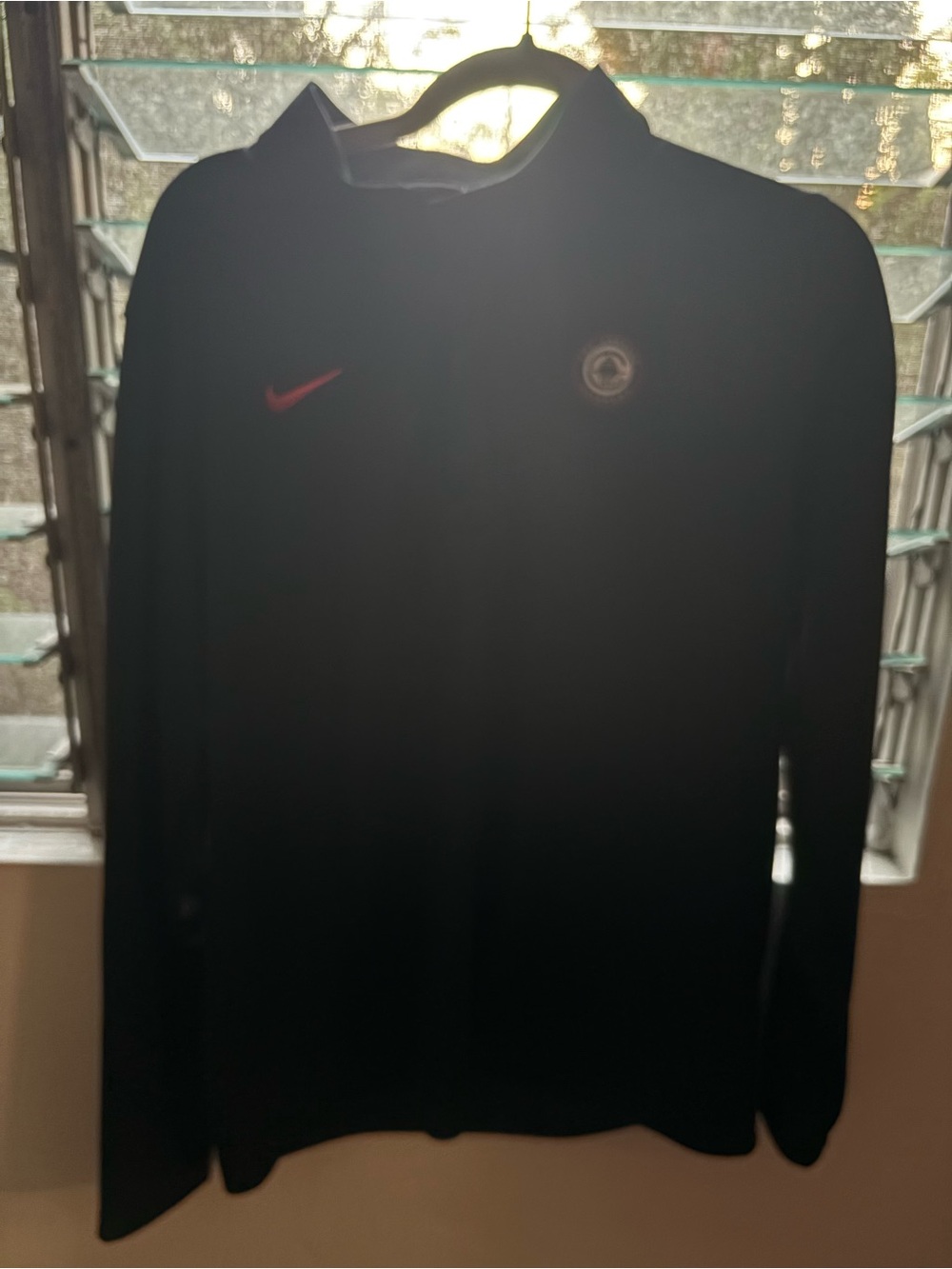 Nike Black Jacket with Red Swoosh and Round Emblem